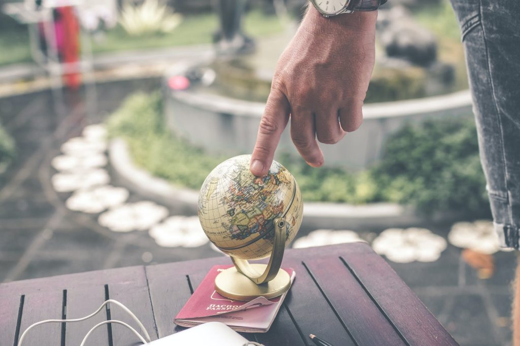 micro niche affiliate marketing - person holding terrestrial globe scale model taken