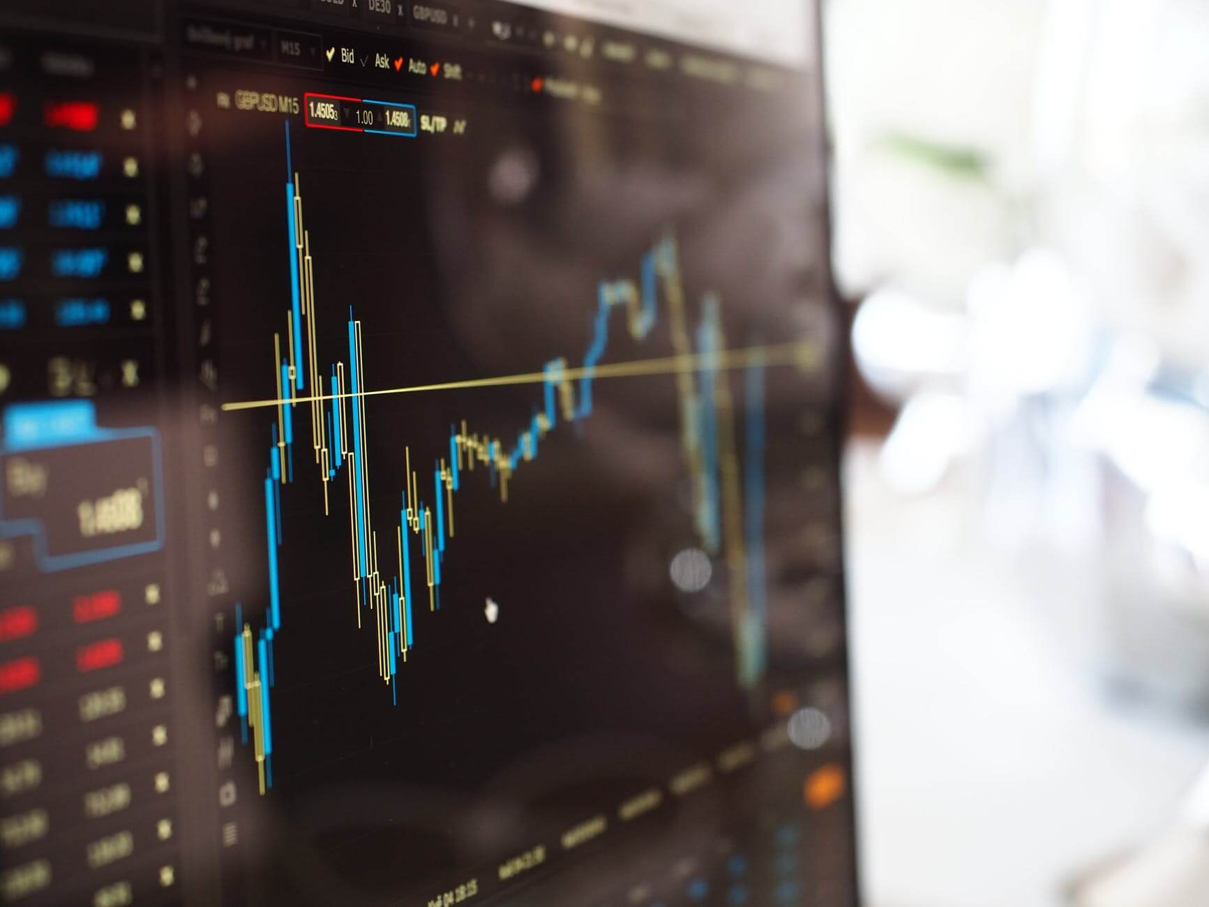 A Complete Guide To All The Online Revenue Models (2026 Update) - online revenue model blue and yellow graph on stock market monitor