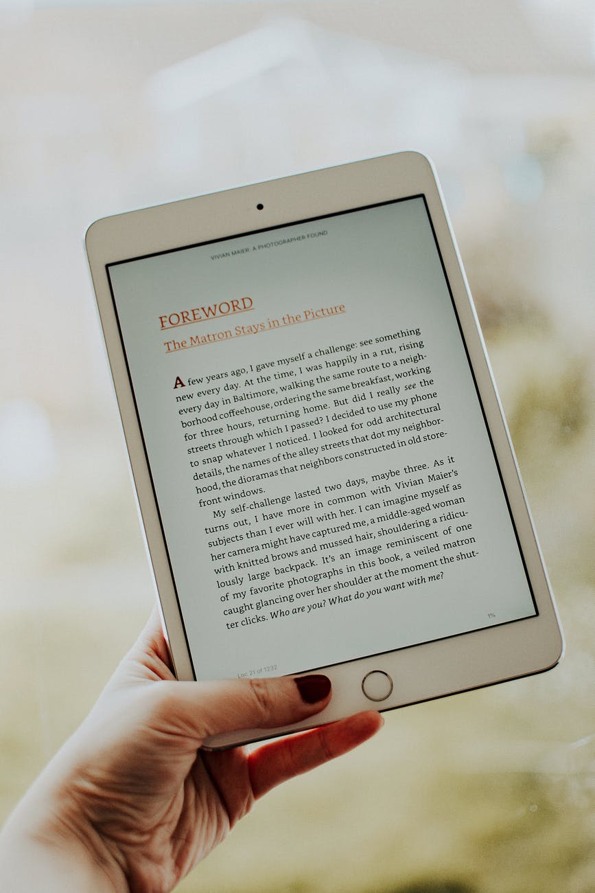 generate passive income online by writing an ebook - photo of person s hand holding ipad