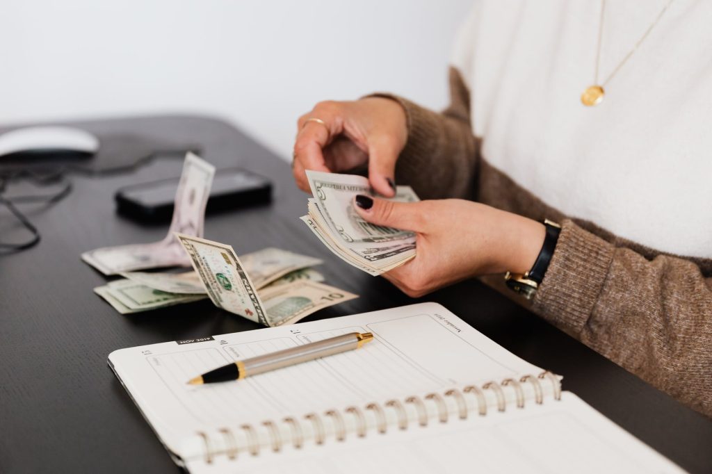 Affiliate Marketing VS Dropshipping - Which Is More Profitable? - affiliate marketing vs dropshipping crop payroll clerk counting money while sitting at table