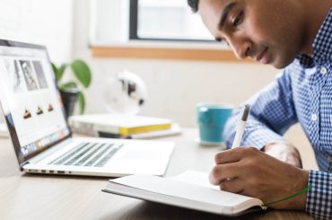 man using ballpoint pen